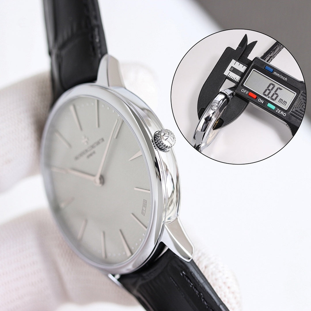 Wristwatch with white dial and black leather strap, side profile with crown visible.