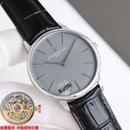 Wristwatch with gray dial and black leather strap, silver case angled on cushion.