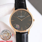 Gold-tone watch with dark dial and black leather strap, dot markers and star balance