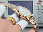 Vacheron Constantin wristwatch with gold-tone case and light dial, side angle view.