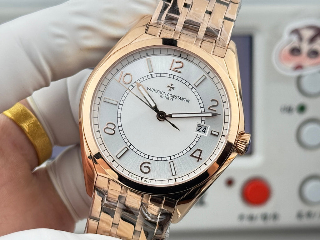 Vacheron Constantin wristwatch close-up with gold-tone case, light dial, date window.