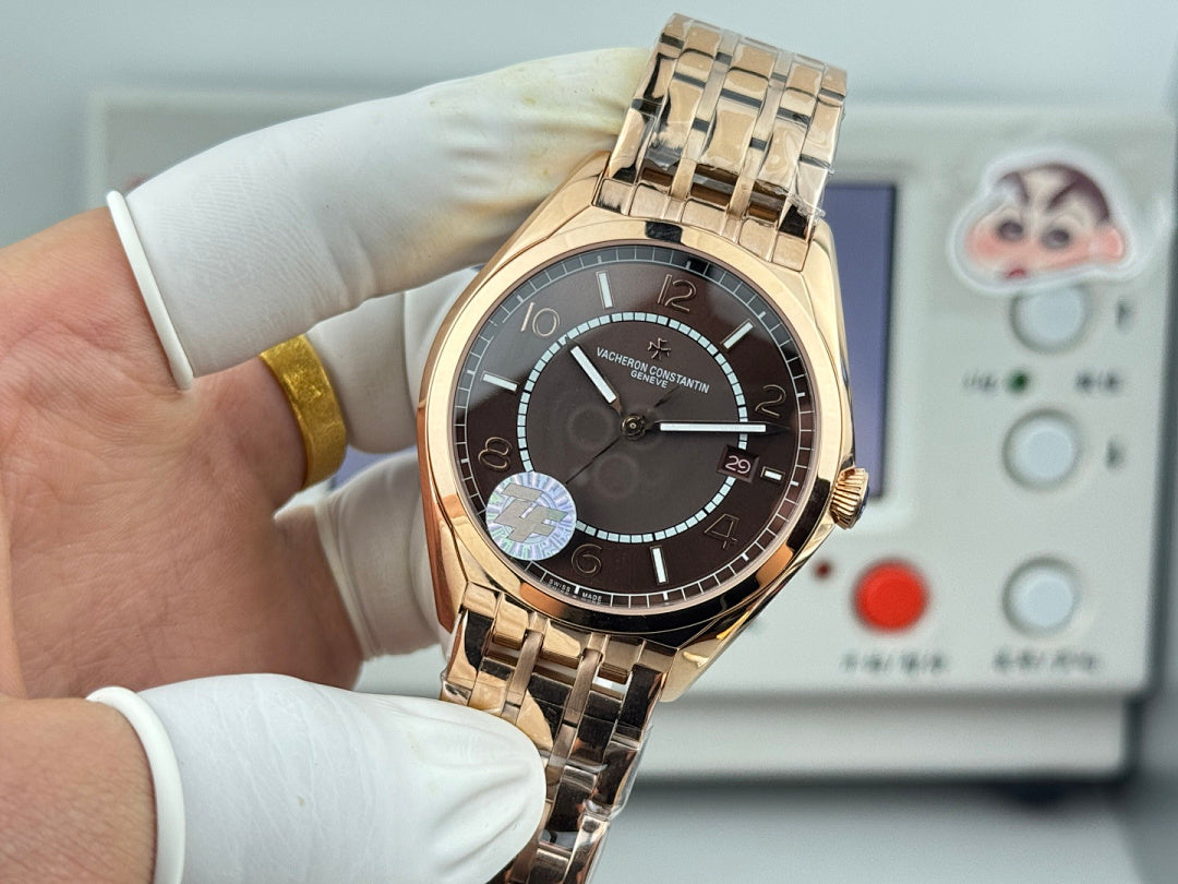 Vacheron Constantin gold-tone wristwatch front view with black dial and metal bracelet