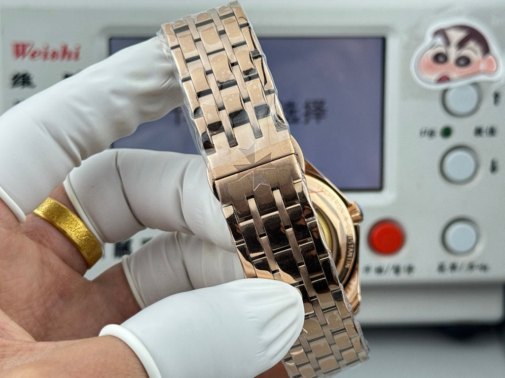 Vacheron Constantin gold-tone wristwatch side view with metal bracelet and crown