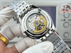 Vacheron Constantin watch close-up with open case showing gold-toned movement and steel strap