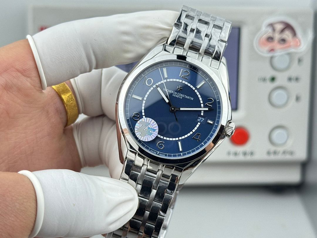 Vacheron Constantin wristwatch front view, blue dial, stainless steel bracelet held by gloves
