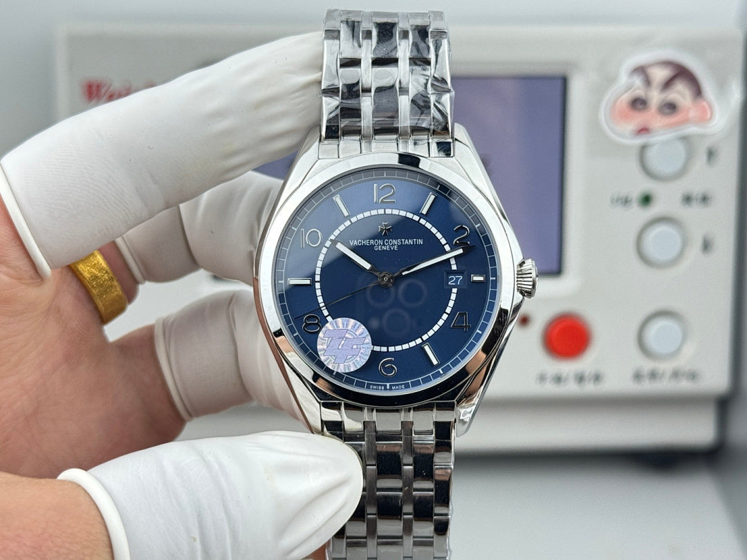 Vacheron Constantin wristwatch with blue face and stainless steel bracelet in gloved hands