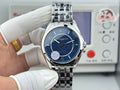 Vacheron Constantin wristwatch with blue dial and stainless steel link bracelet on glove hands