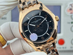 Gold-tone wristwatch close-up with black dial, indices, and metal bracelet