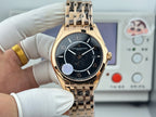 Gold-tone wristwatch with black dial, baton markers, and metal link bracelet