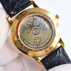 Automatic watch caseback in gold with engraved movement and serial markings, black strap