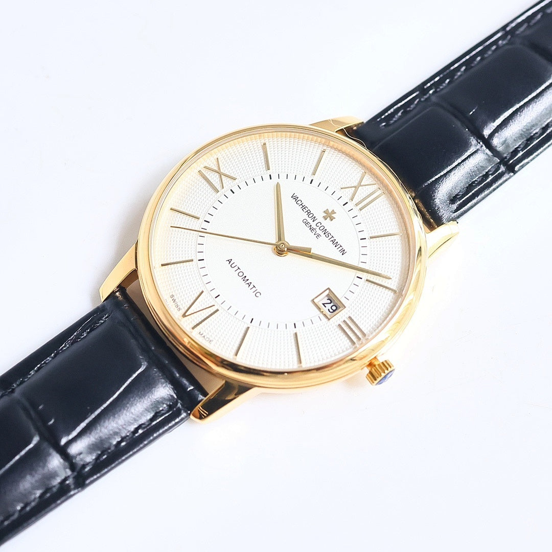 Automatic wristwatch with white textured dial, Roman numerals, date window, gold case, black strap