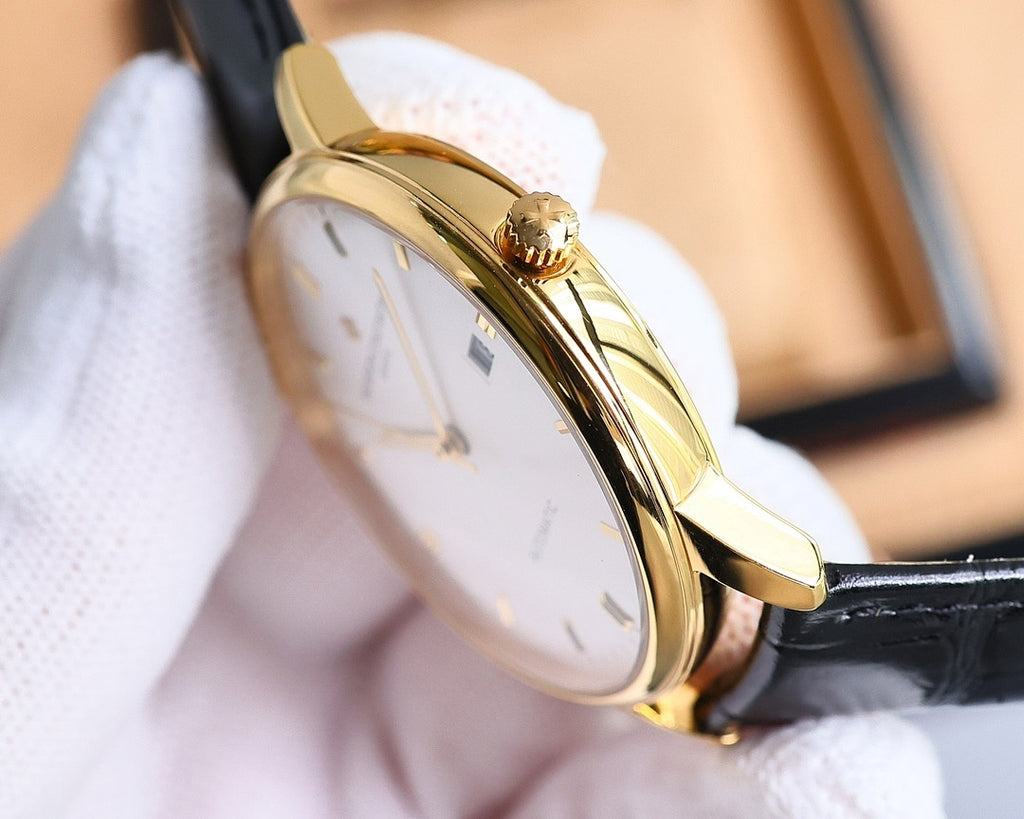 Automatic wristwatch side view with gold-tone case and crown, black leather strap, white dial