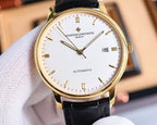 Automatic wristwatch with gold-tone case, white dial, black leather strap, date 18, close-up