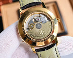 Automatic wristwatch caseback with gold-tone movement, black leather strap