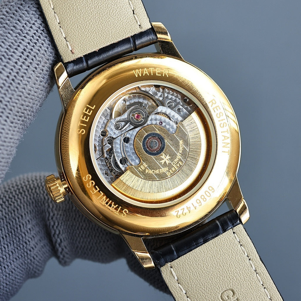 Vacheron Constantin watch caseback in gold with visible mechanical movement under glass.