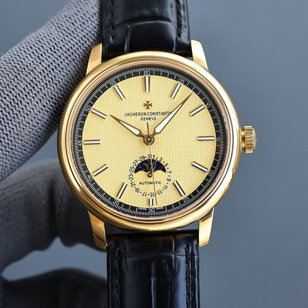 Vacheron Constantin watch with gold case, black leather strap, yellow dial, automatic subdial.