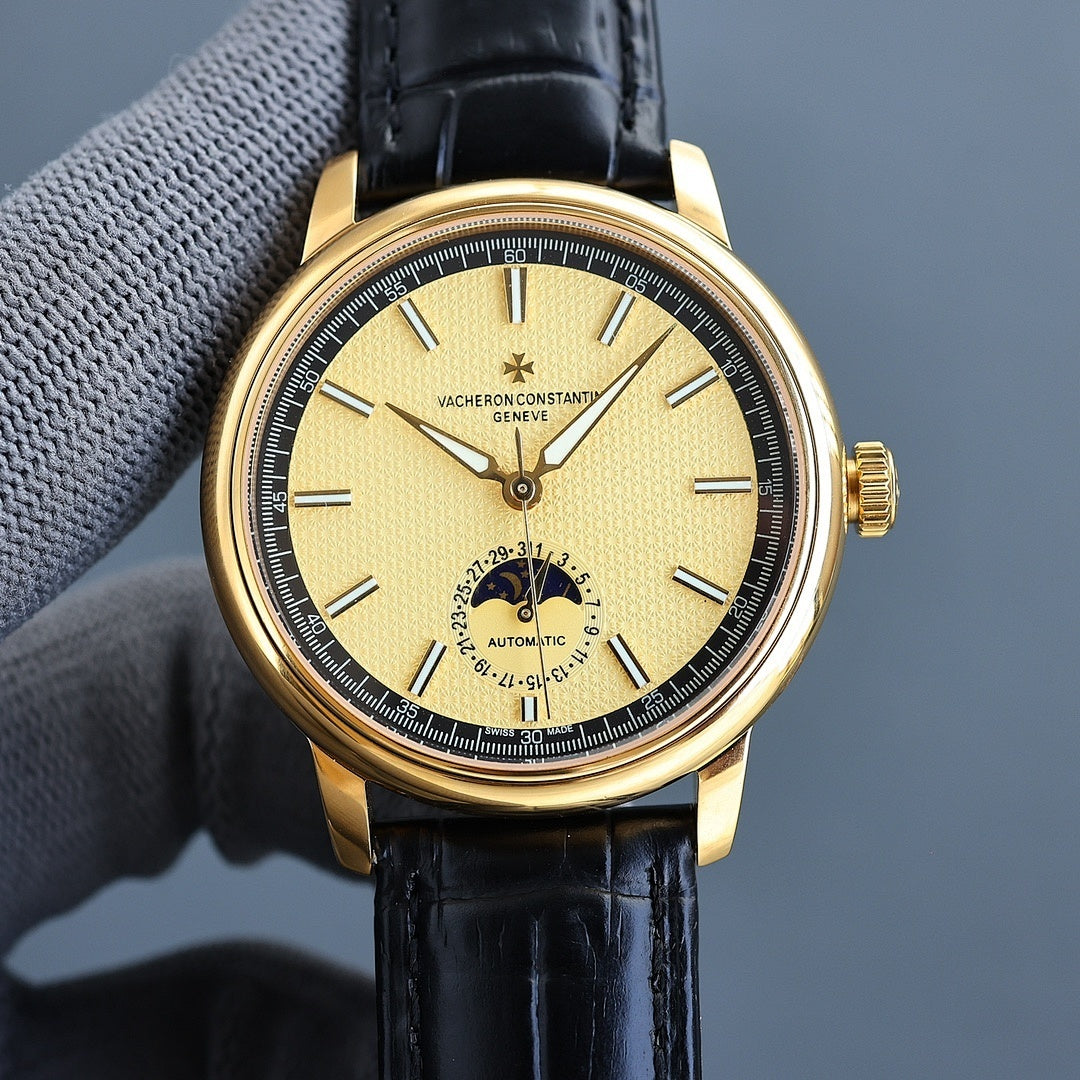 Vacheron Constantin watch with gold case, black leather strap, yellow dial, automatic subdial.