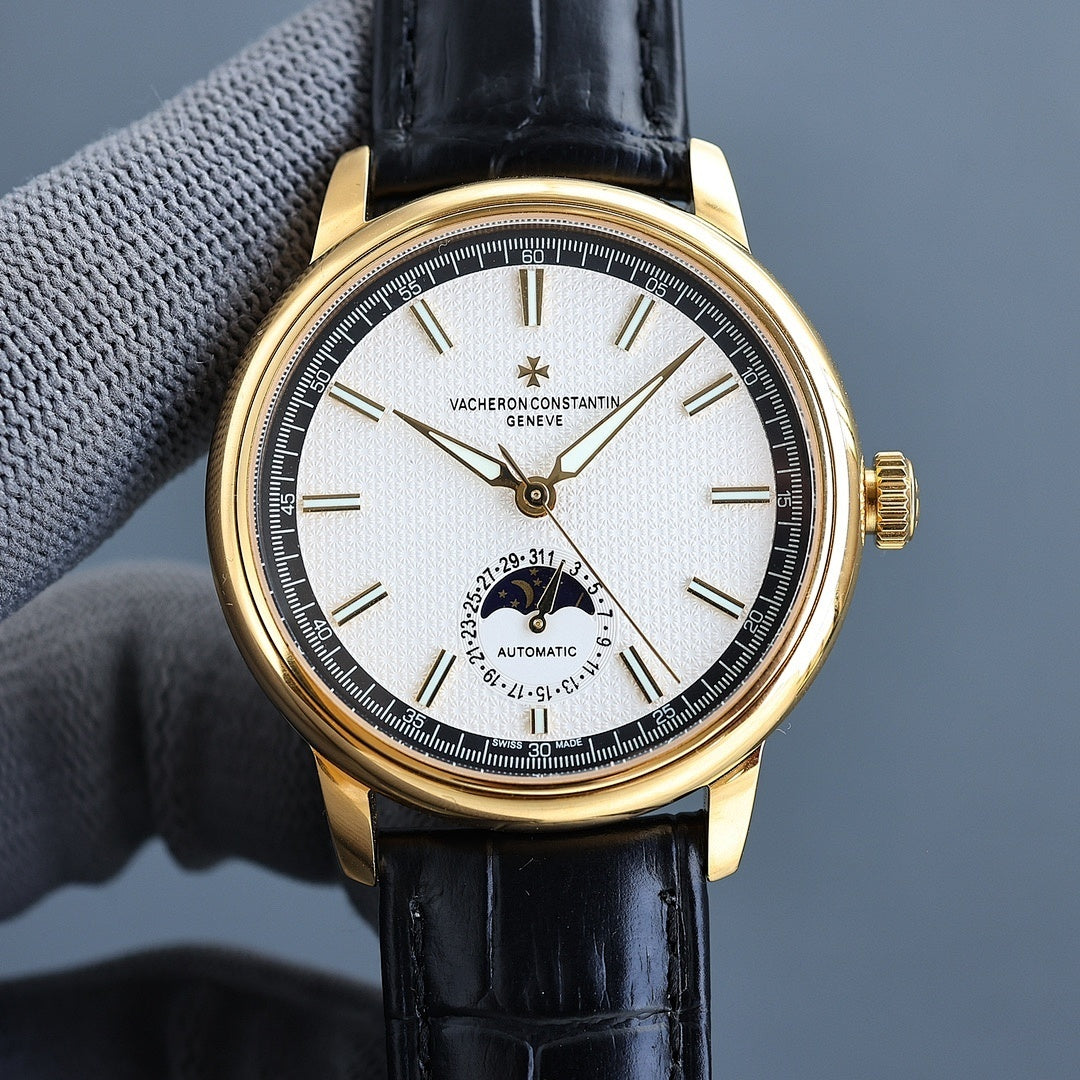 Vacheron Constantin watch with gold case, black leather strap, white dial, gold hands.