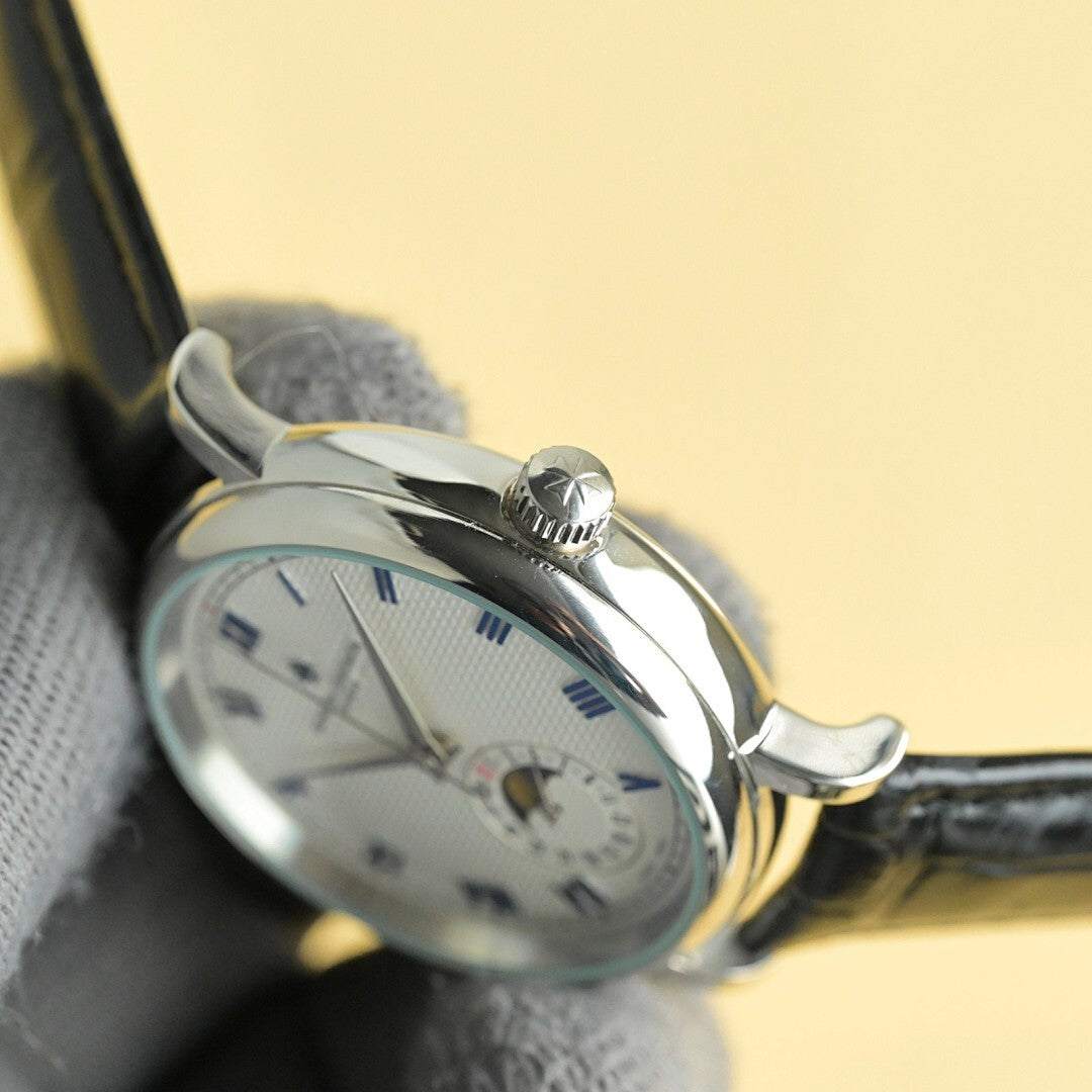 Vacheron Constantin watch with white dial and black leather strap, crown side angle