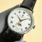 Vacheron Constantin watch with white dial, Roman numerals, black leather strap, side crown
