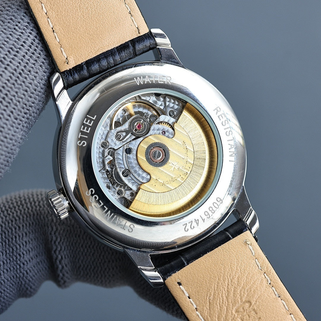 Vacheron Constantin watch caseback with visible movement, tan leather strap