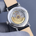 Vacheron Constantin watch caseback with gold-toned movement on tan leather strap