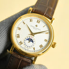 Vacheron Constantin watch front view with gold bezel, white dial, brown leather strap.