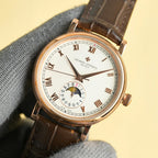 Vacheron Constantin watch dial close-up with gold hands, Roman markers, brown leather strap.