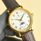 Vacheron Constantin watch with gold case, white dial featuring subdial, brown leather strap.