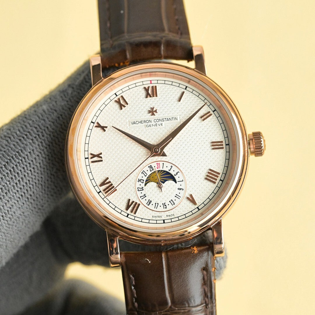 Vacheron Constantin watch with cream-white dial, Roman numerals, gold case, brown leather strap.