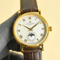 Vacheron Constantin watch with gold case, white dial, brown leather strap, Roman numerals.