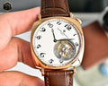Vacheron Constantin watch with white dial, gold case, brown leather strap, visible movement