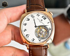 Vacheron Constantin watch with white dial, gold case, brown leather strap, visible movement