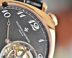 Mechanical watch dial close-up with black face and rose-gold bezel
