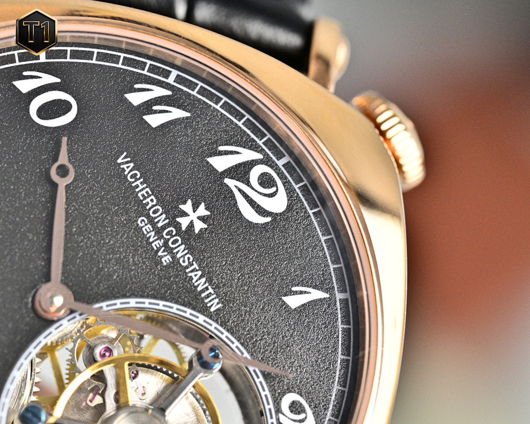 Mechanical watch dial close-up with black face and rose-gold bezel