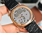 Mechanical wristwatch caseback showing silver movement in rose-gold housing