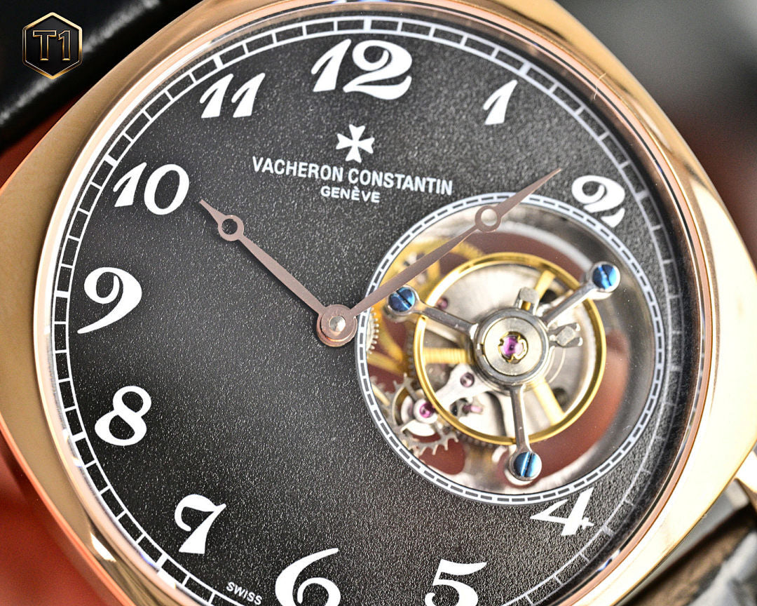 Mechanical wristwatch dial close-up with black face, roman numerals, inner display