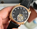 Mechanical wristwatch with black dial, rose-gold case, visible movement, leather strap