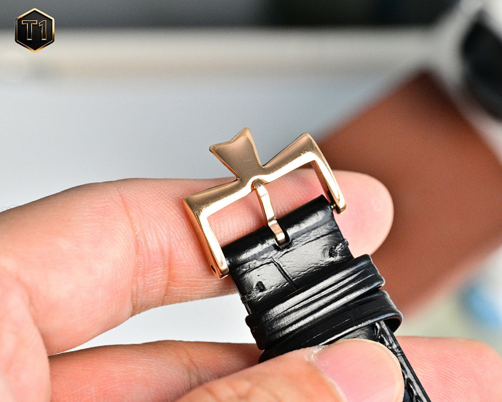 Mechanical wristwatch buckle and black leather strap with rose-gold case