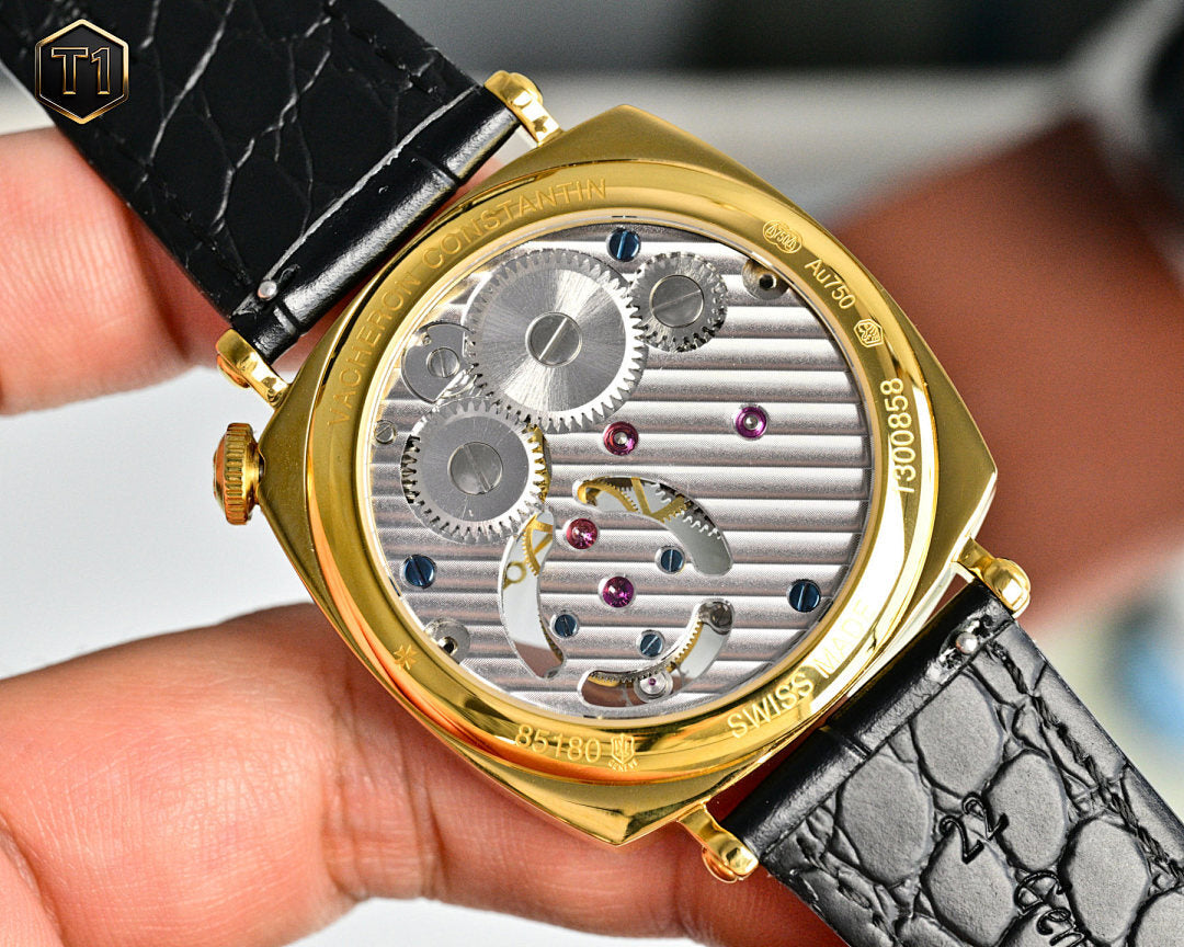 Vacheron Constantin open caseback showing silver gears with gold bezel and blue strap