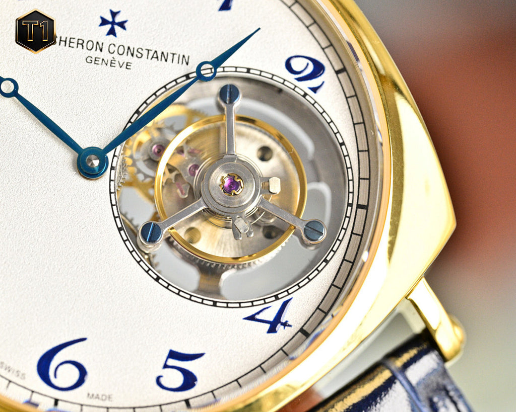 Vacheron Constantin watch face with visible movement and blue numerals on white dial