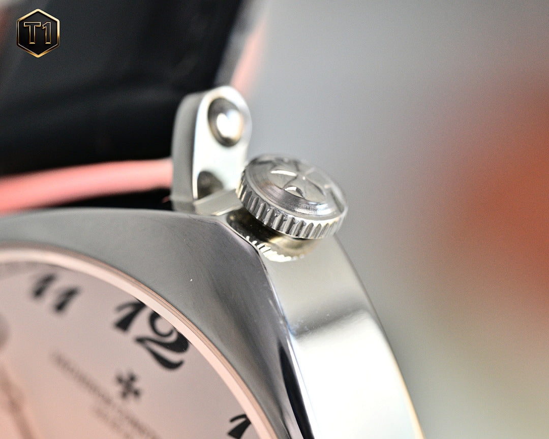 Stainless steel crown and crown guard on a black leather strap watch, side detail.