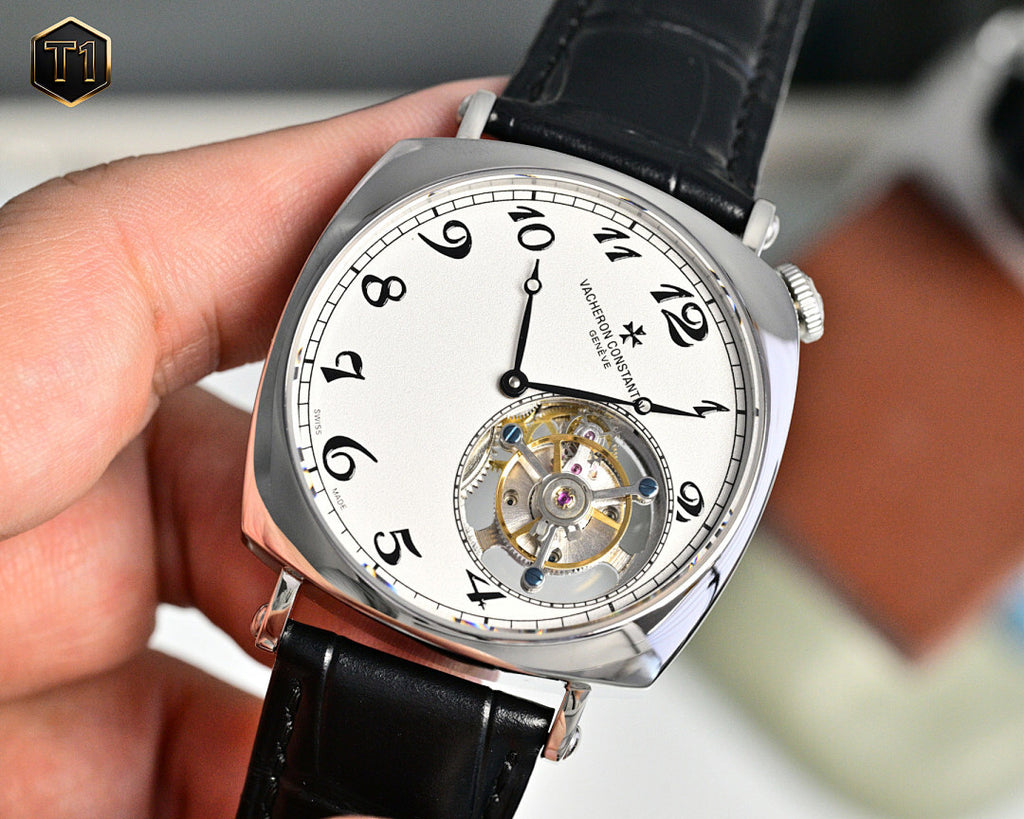 Stainless steel skeleton watch with black leather strap, white dial, exposed movement detail.