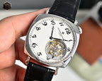 Stainless steel skeleton watch with black leather strap, white dial, exposed movement detail.