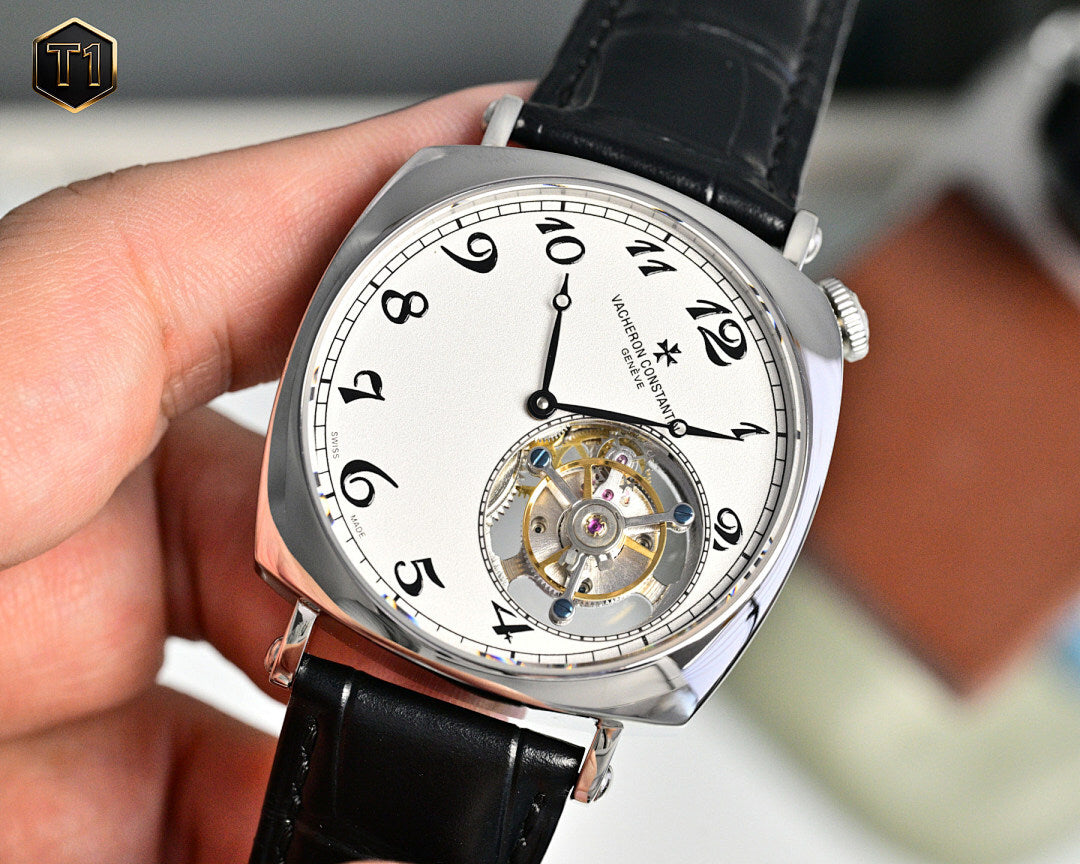 Stainless steel skeleton watch with black leather strap, white dial, exposed movement detail.