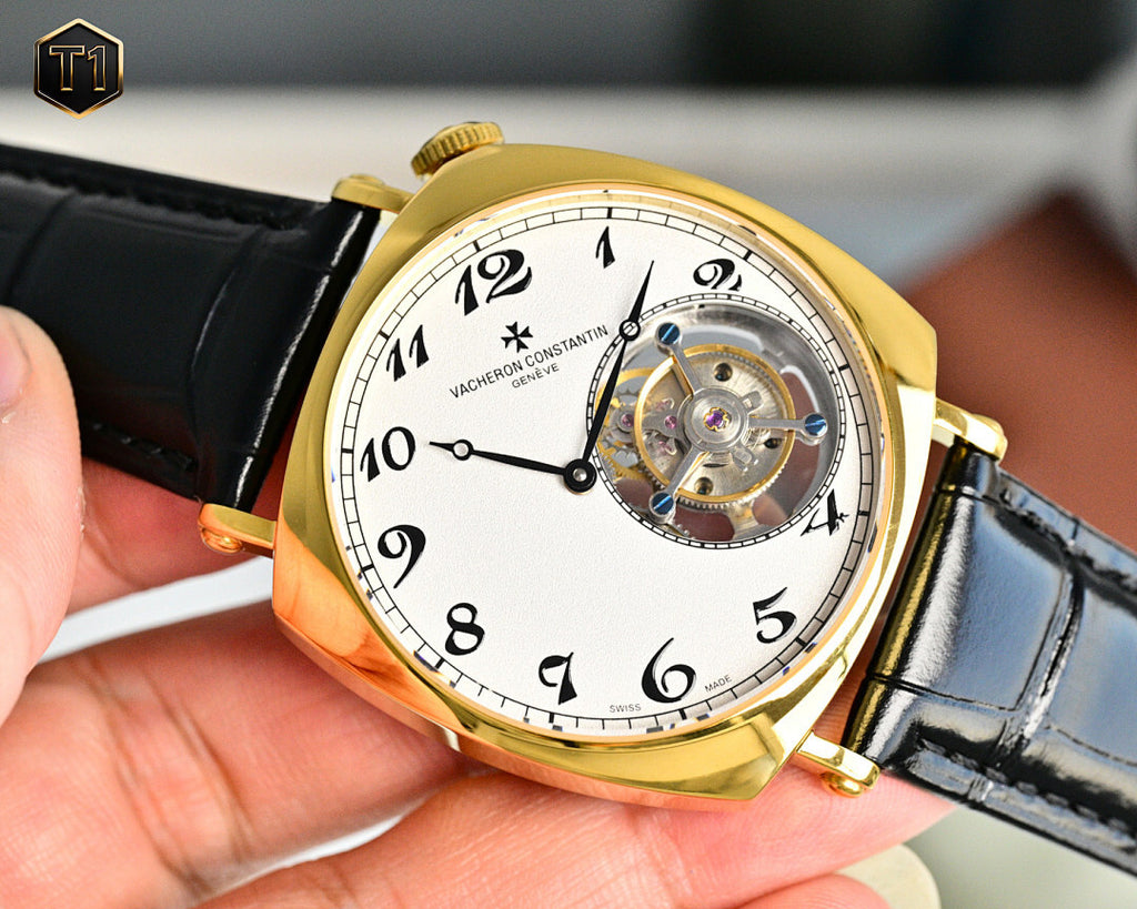 Vacheron Constantin watch with gold case, black leather strap, and visible tourbillon movement