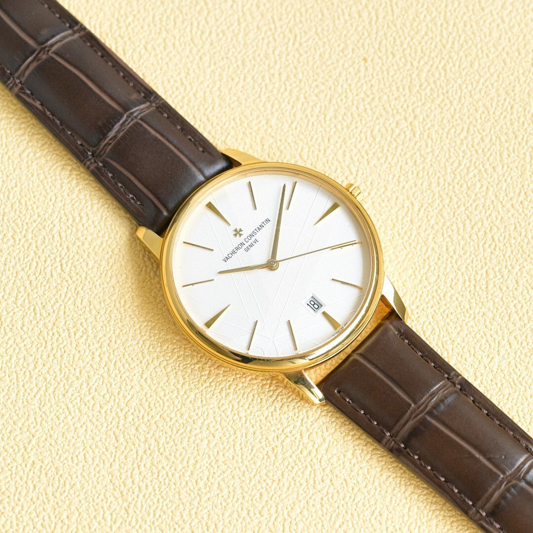 Vacheron Constantin watch with white dial, gold markers, brown leather strap