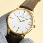 Vacheron Constantin watch with white dial, gold case, brown leather strap, date window