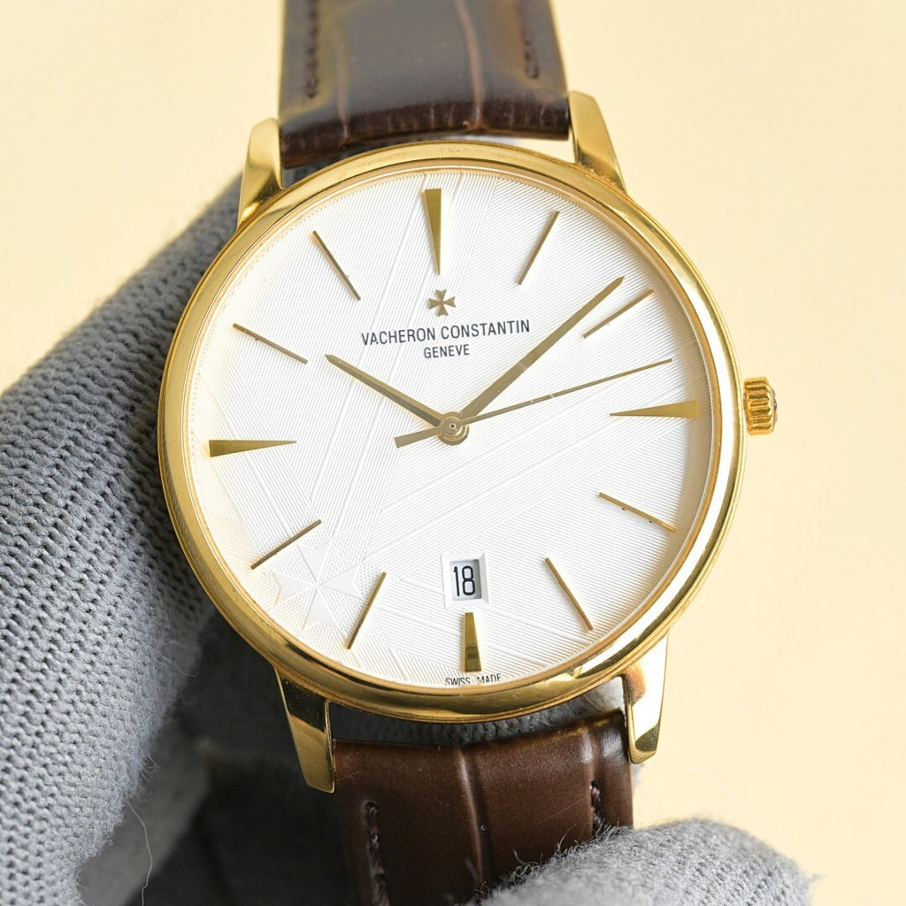 Vacheron Constantin watch with white dial, gold case, brown leather strap, date window 18