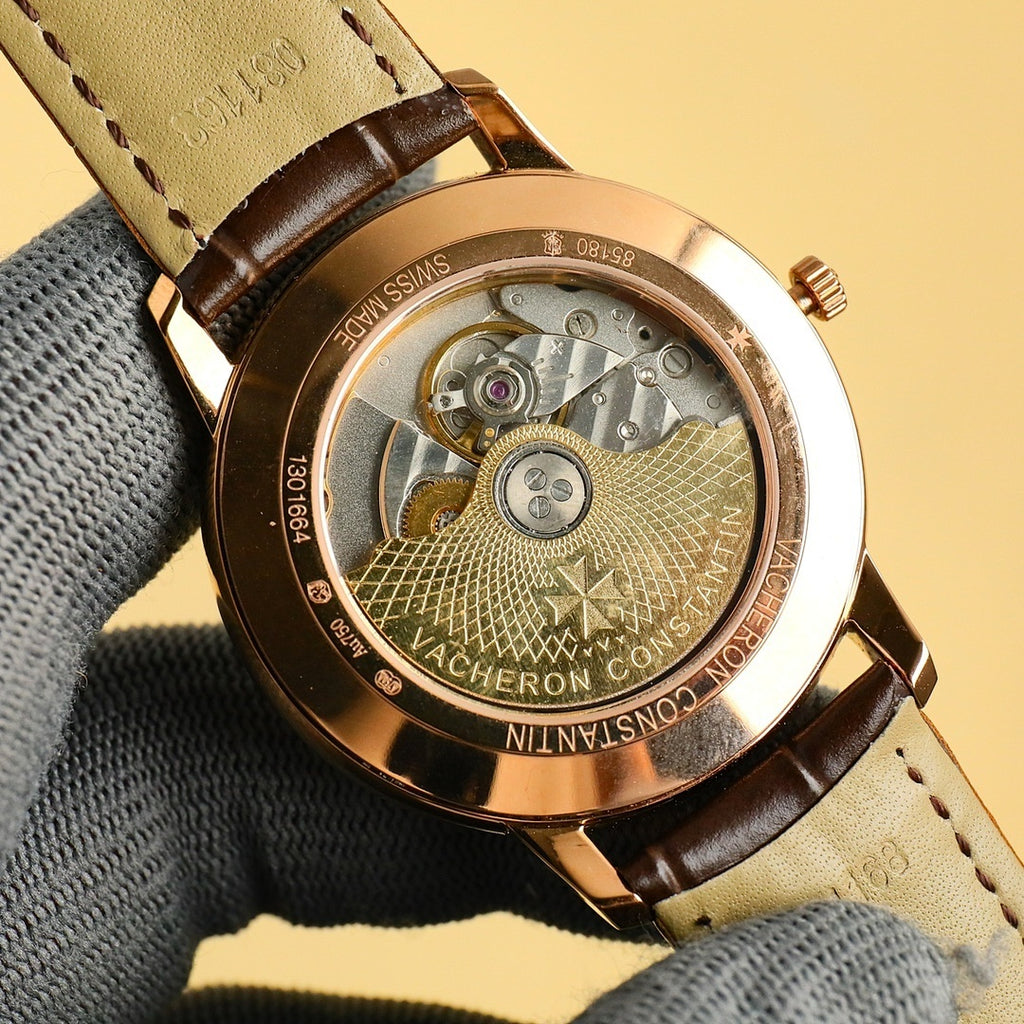 Gold Vacheron Constantin watch caseback showing mechanical movement under glass